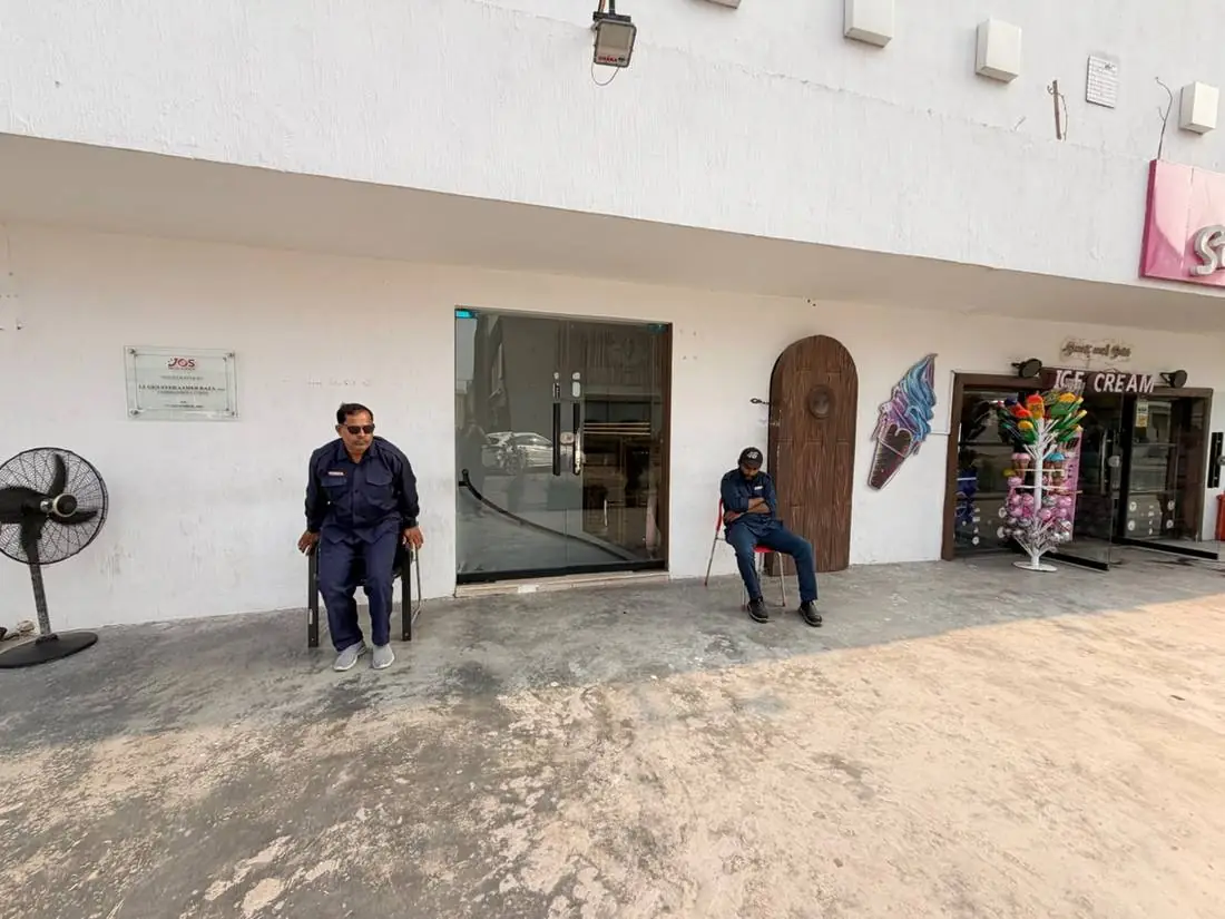 The main entrance of Joy of Science Lahore with staff at the doors