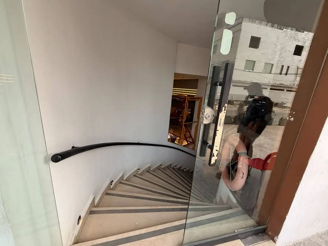 The curved staircase descending into Joy of Science Lahore